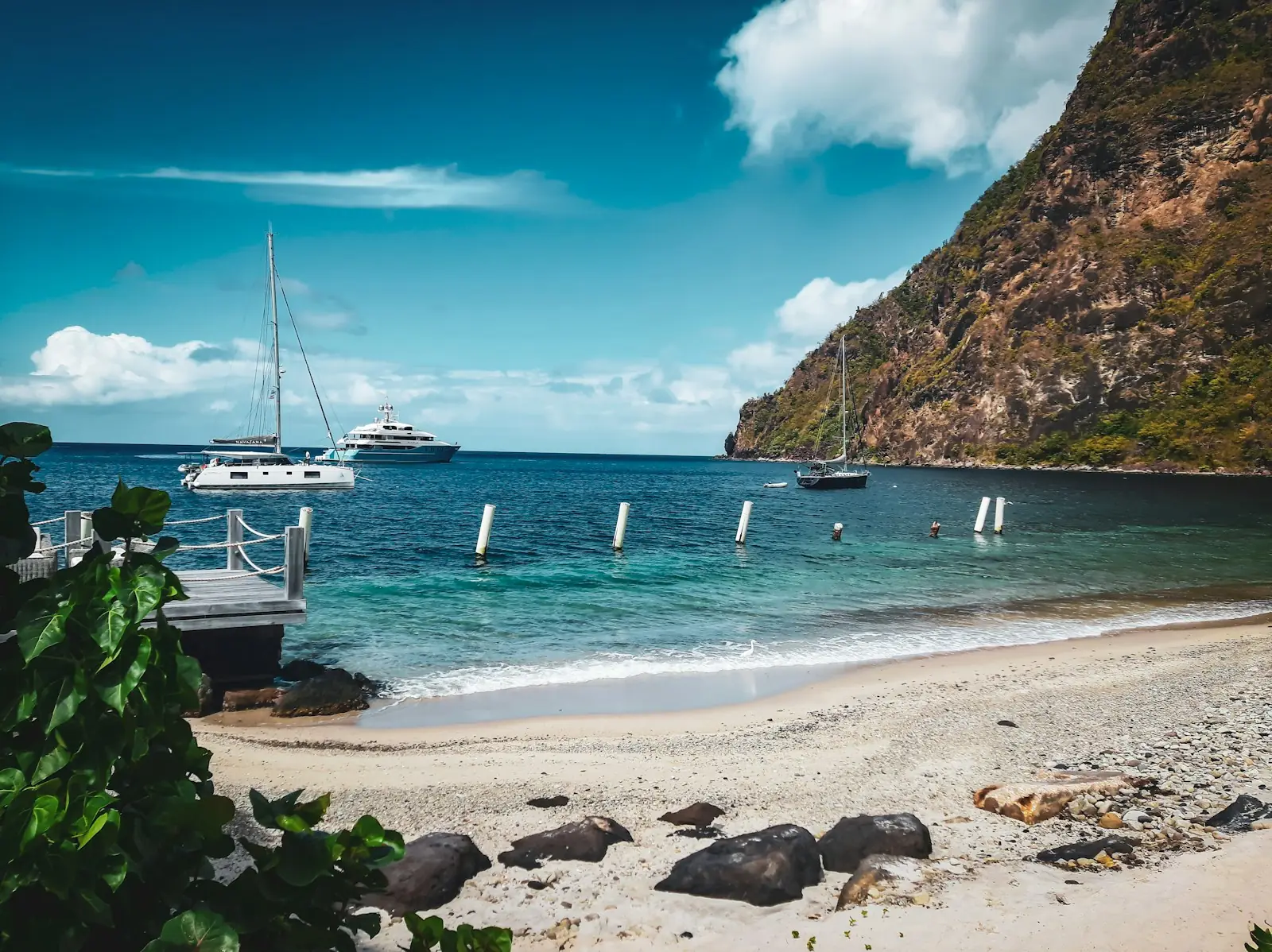 Beach and moored yachts below Petit Piton, St Lucia – St Lucia Citizenship by Investment