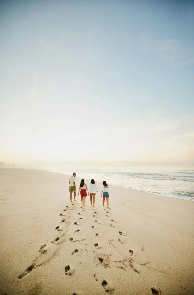 Family walking on a beach: benefits of second citizenship and a golden visa